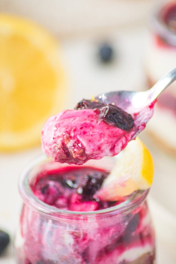 Creamy berry yogurt parfait with fresh blueberries and lemon zest.