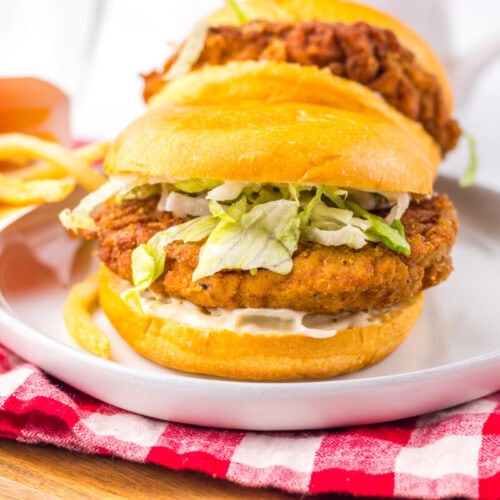 Delicious fried chicken sandwich with lettuce and pickles on a soft bun. Perfect for lunch or dinner.