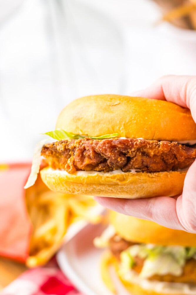 Crispy fried chicken sandwich with lettuce in a soft bun.