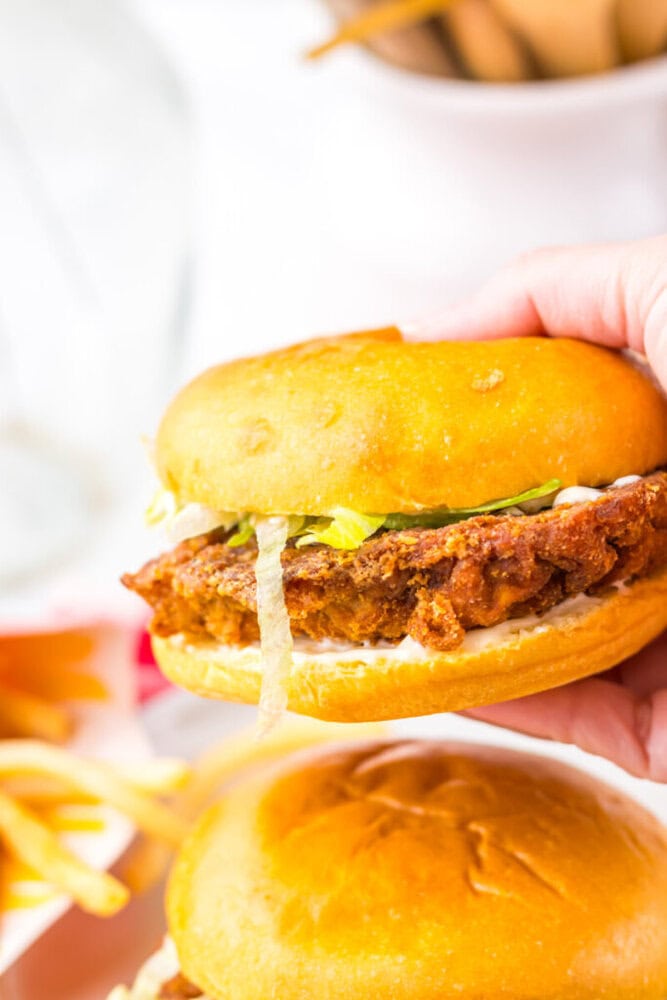 Delicious crispy fried chicken sandwich with lettuce and bun.