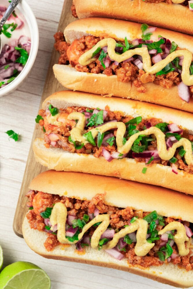 Delicious ground beef tacos with fresh vegetables and mustard sauce on soft buns.