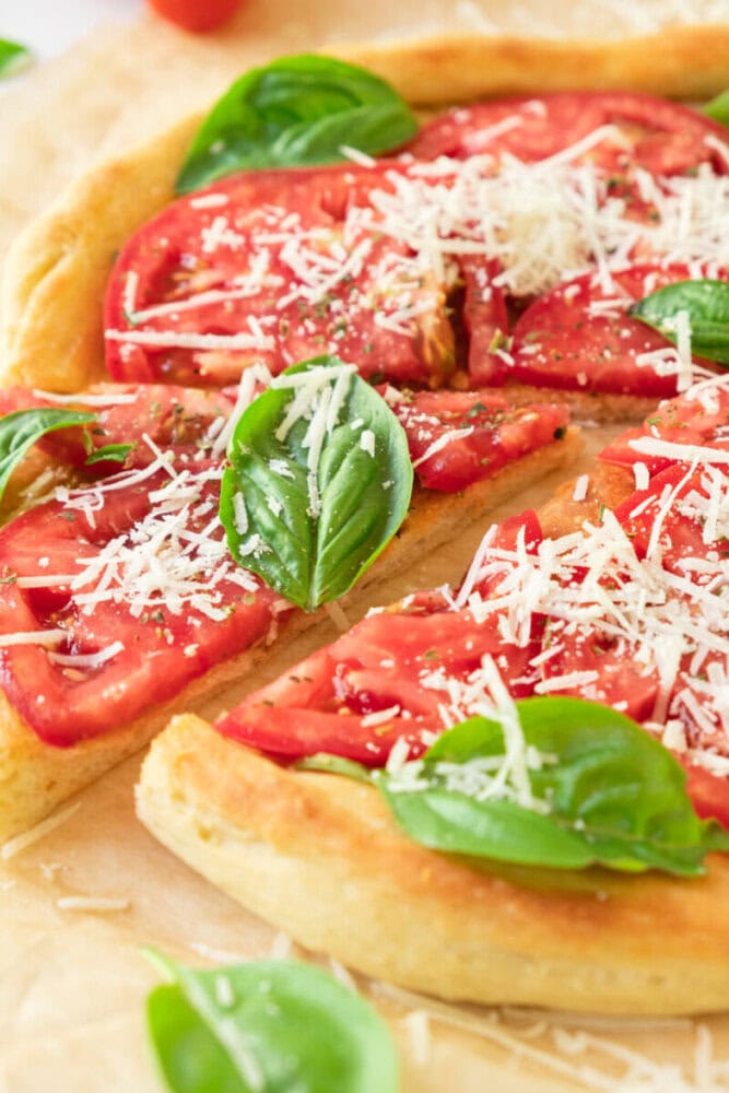 Delicious homemade flatbread topped with fresh tomatoes, basil, and grated cheese.