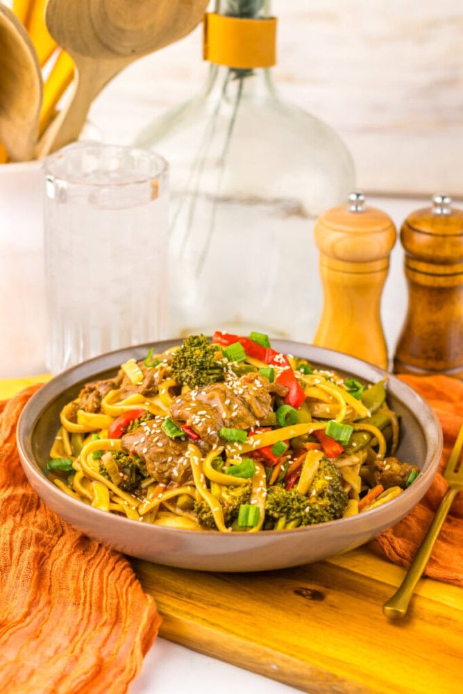 Delicious beef and broccoli stir-fry with colorful vegetables on a rustic plate.