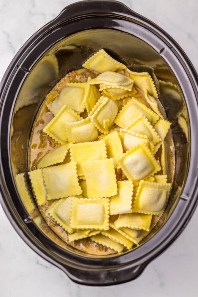 Fresh ravioli in a slow cooker for easy homemade pasta meal.