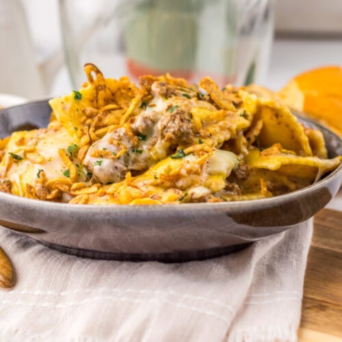 Delicious spicy chicken and egg curry served in a black bowl with bread on the side.