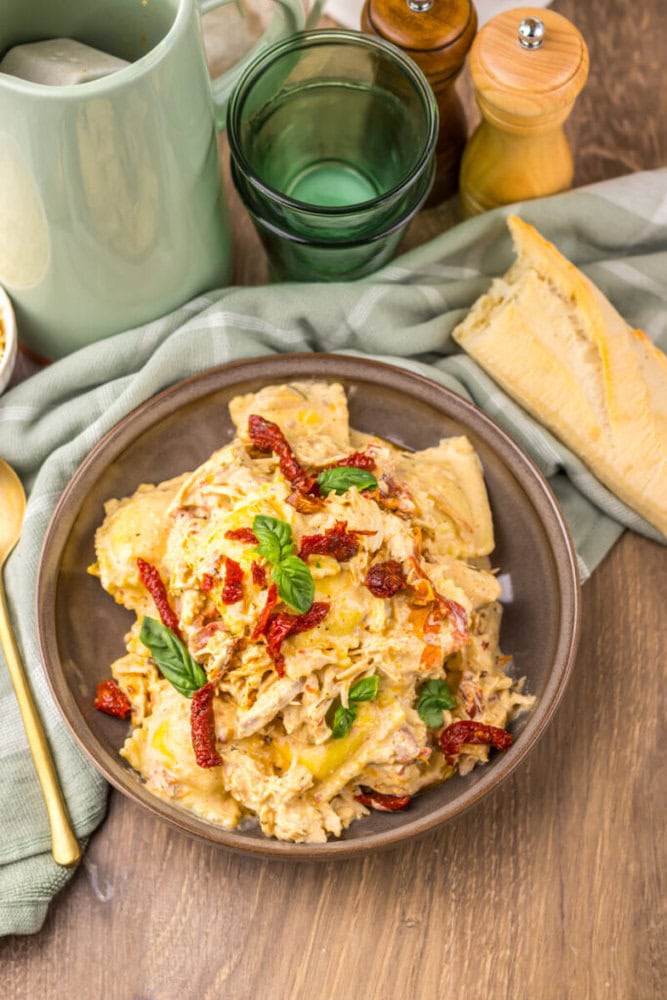 Delicious creamy chicken Alfredo pasta with sun-dried tomatoes and fresh herbs. Perfect comfort food.