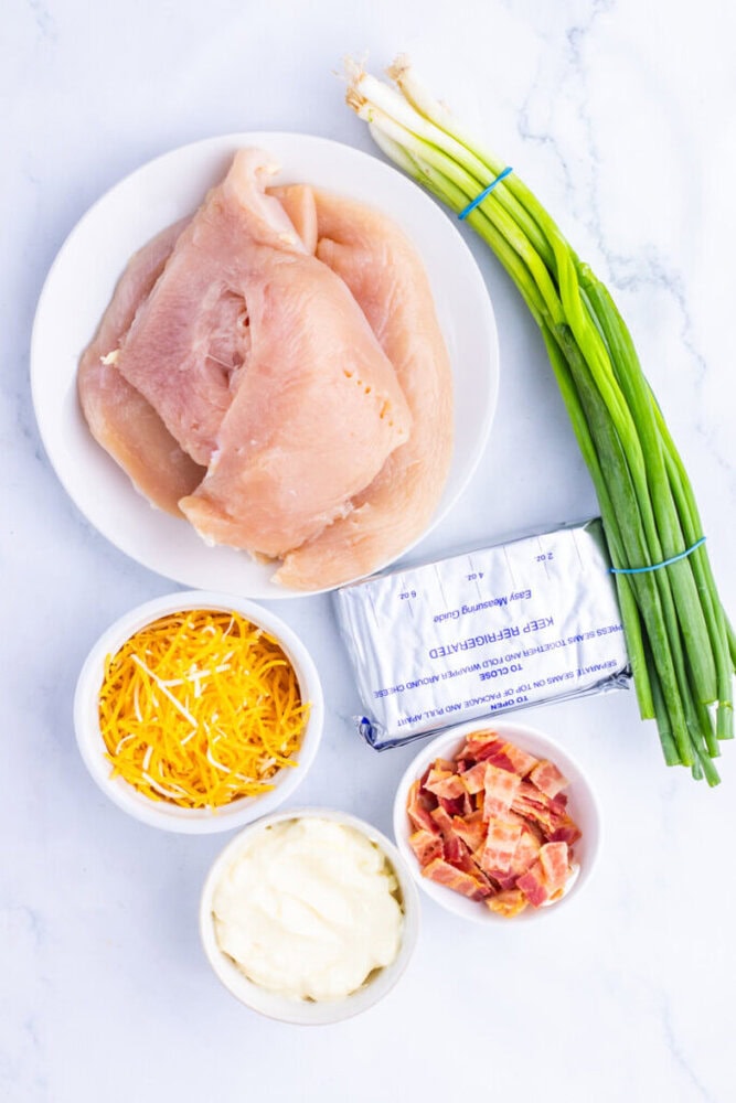 Chicken and green onions for cooking or recipe preparation.