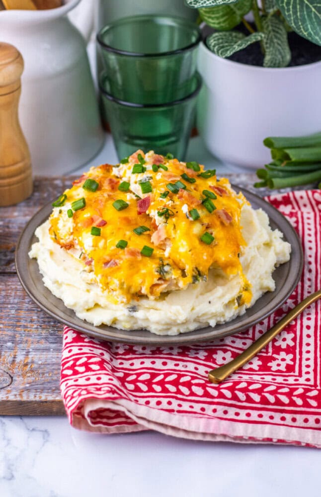 Delicious cheesy chicken pot pie topped with melted cheese and green onions.
