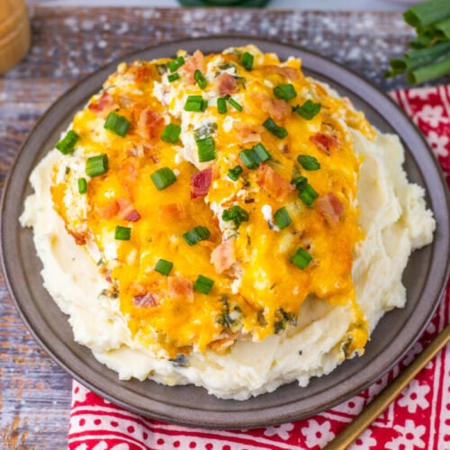 Delicious chicken topped with cheese and green onions over creamy mashed potatoes.