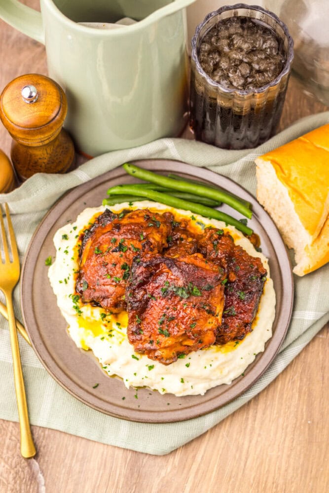 Delicious baked chicken served over creamy mashed potatoes with fresh green beans on the side. Perfe.