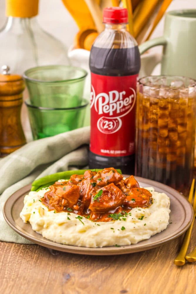 Delicious beef stew served over creamy mashed potatoes with rich gravy and tender meat chunks. Perfe.
