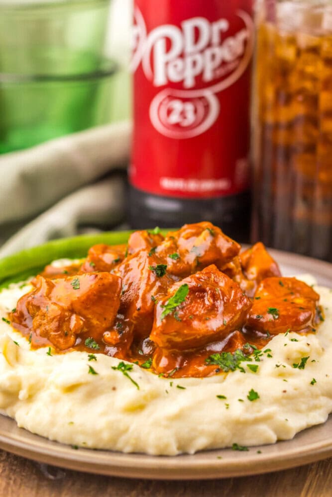 Delicious beef stew served over creamy mashed potatoes with herbs.