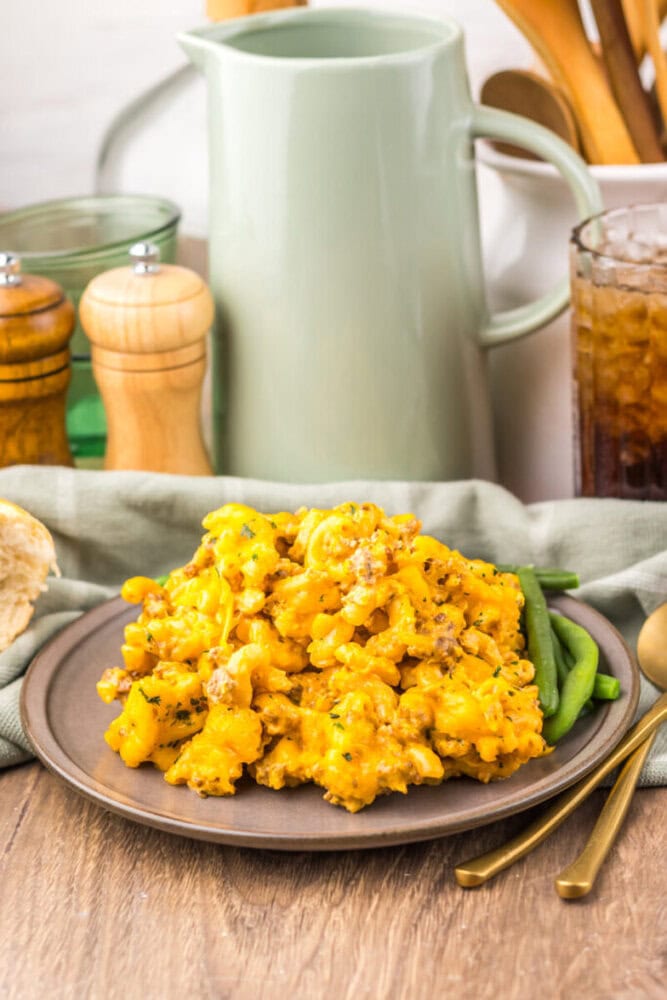 Delicious cheesy cauliflower hash browns served on a rustic plate with green beans. Perfect for brea.