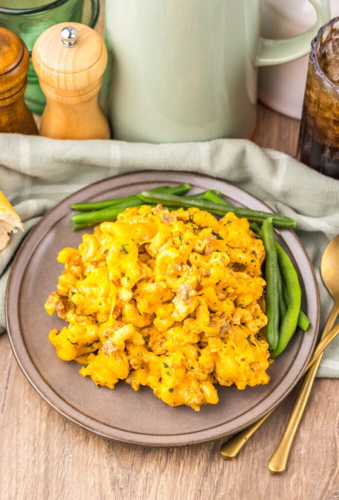 Delicious cheesy mashed potatoes served with fresh green beans on a rustic plate. Perfect comfort fo.