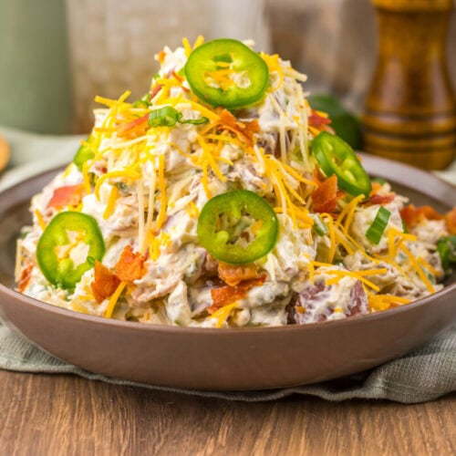 Delicious chicken taco salad topped with jalapeños, cheese, and fresh vegetables.