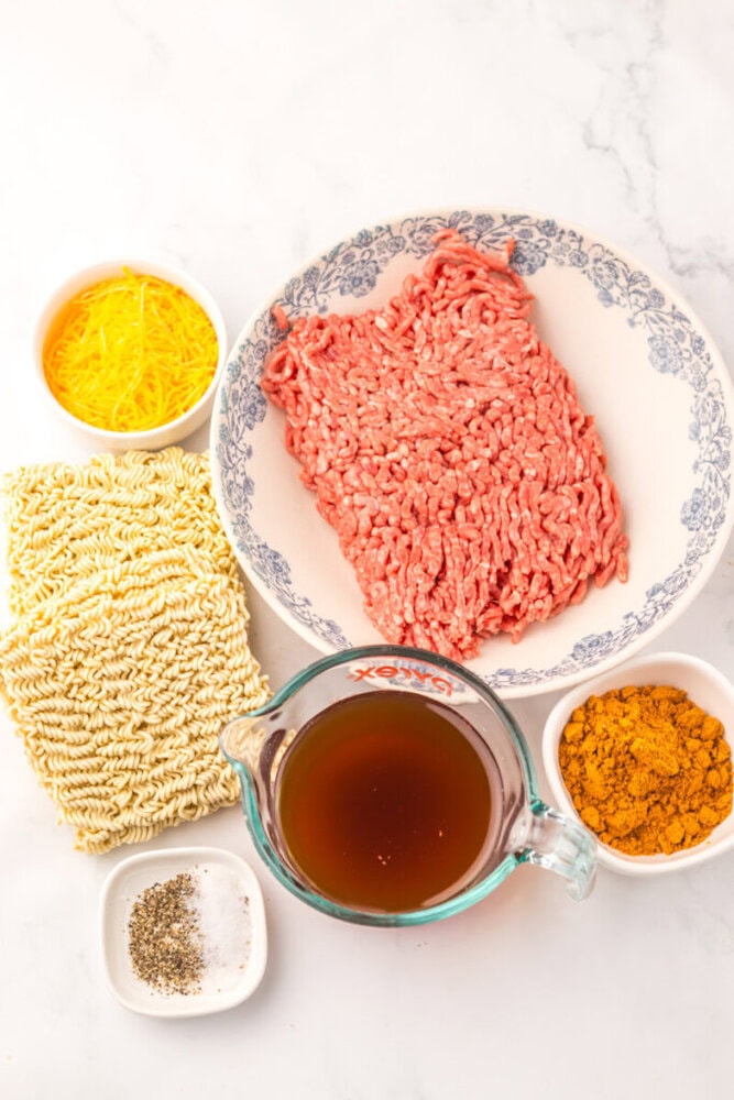 Ground beef in a white and blue patterned bowl, ready for taco filling.