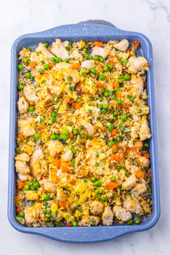 Delicious chicken and rice casserole with vegetables in a blue baking dish.