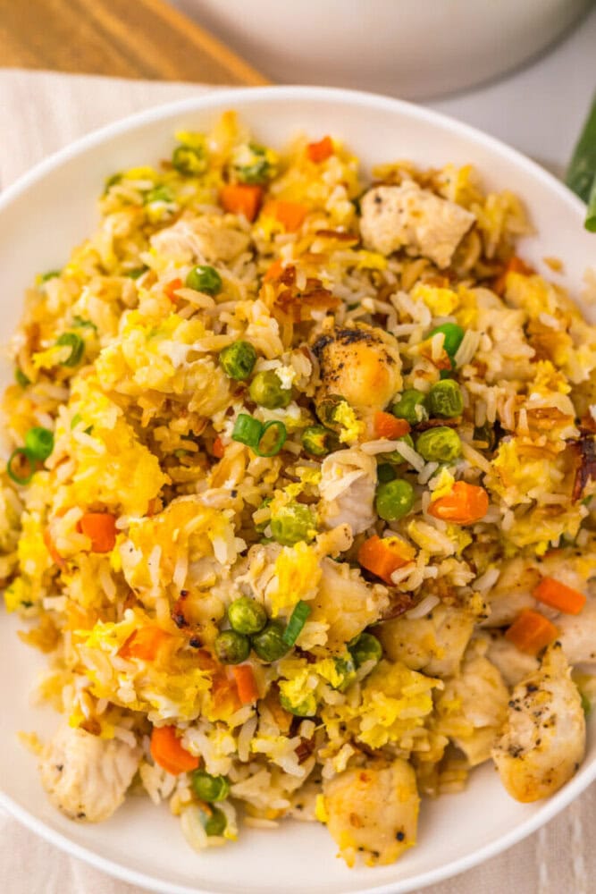Delicious chicken and vegetable fried rice with peas, carrots, and scrambled eggs.