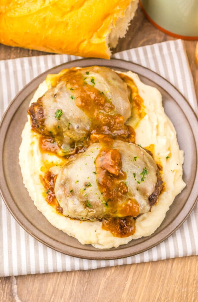 Delicious baked chicken thighs topped with flavorful gravy and herbs. Perfect for a hearty, comforti.