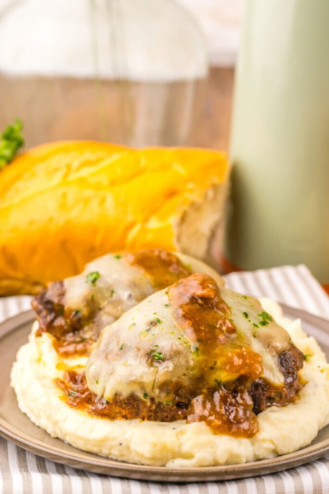 Juicy meatloaf topped with gravy served over creamy mashed potatoes.