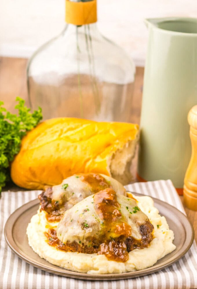 Delicious chicken pot pie topped with melted cheese and gravy, served with mashed potatoes.