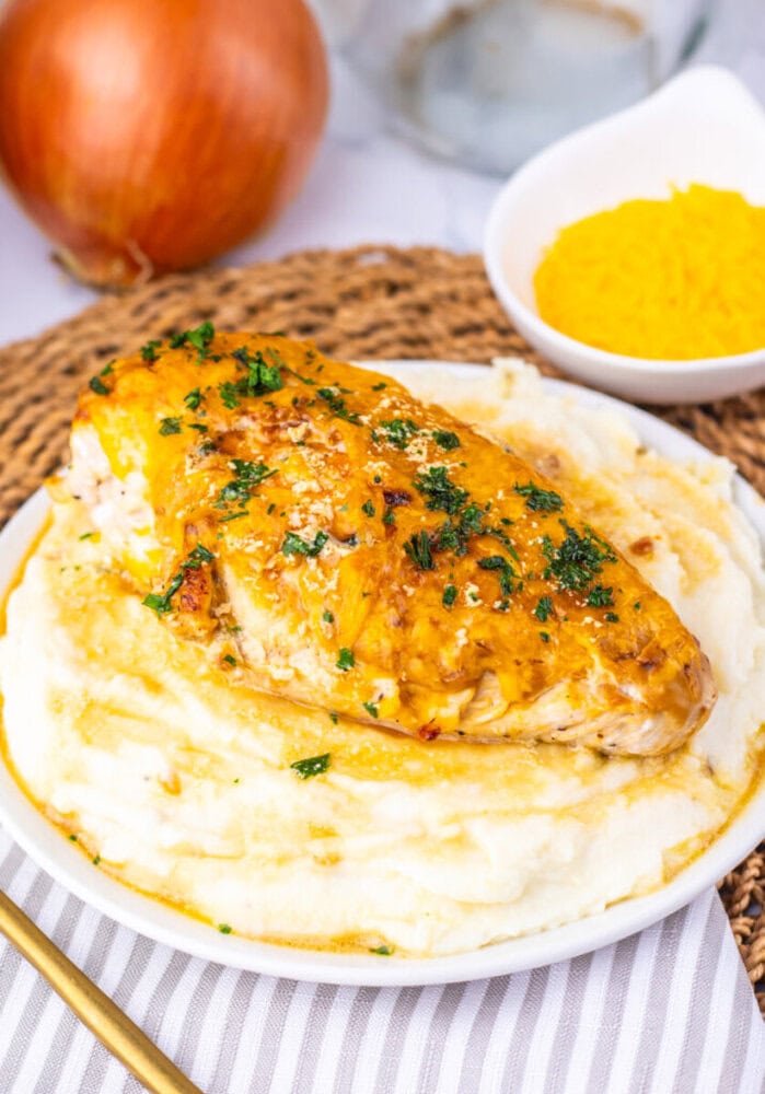 Juicy grilled chicken served over creamy mashed potatoes with herbs.