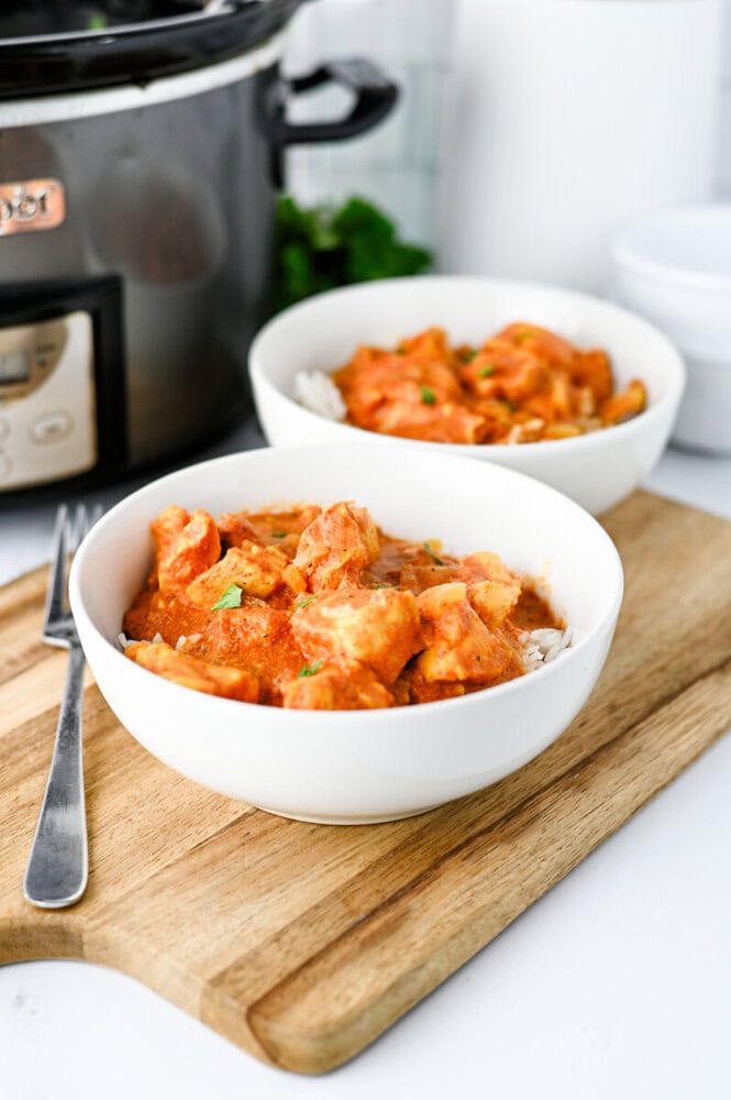 Delicious creamy chicken curry served in white bowls, perfect for a comforting meal.