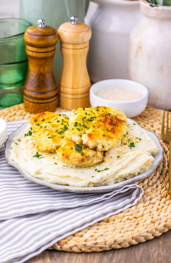 Creamy chicken Caesar bake with golden-brown chicken pieces on mashed potatoes garnished with parsley