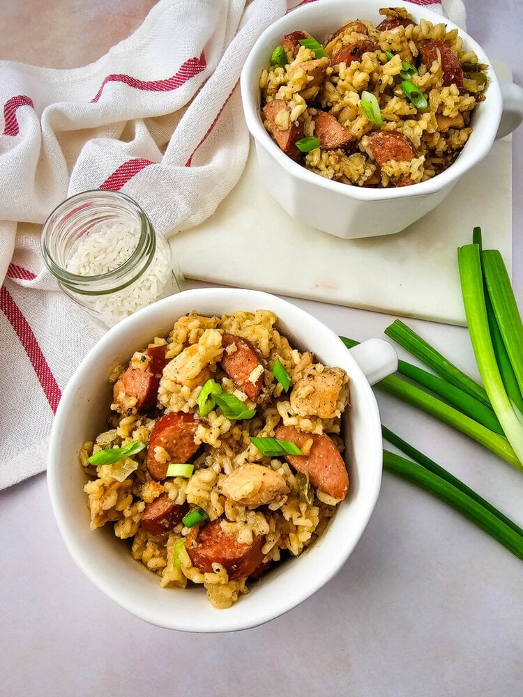 Hearty chicken and sausage rice bowl garnished with green onions.