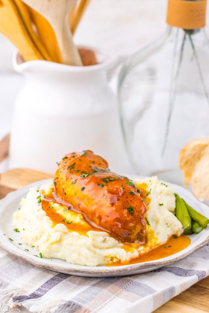 Delicious baked chicken breast topped with savory gravy served over creamy mashed potatoes. Perfect.
