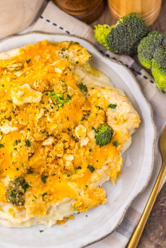 Delicious broccoli chicken casserole with cheesy topping and fresh broccoli florets.