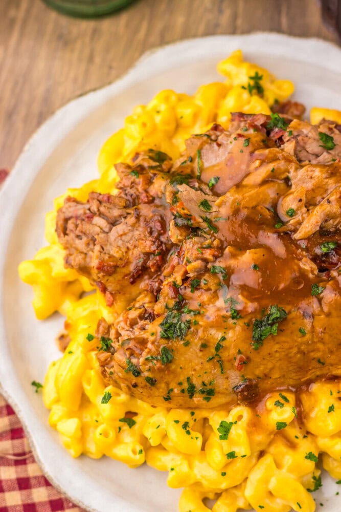 Slow Cooker Dr Pepper BBQ Brisket plated with buttered corn and parsley garnish