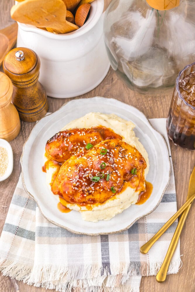 Delicious chicken parmesan with marinara sauce and melted cheese on a bed of mashed potatoes.
