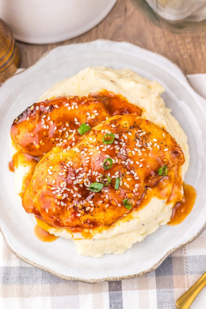 Delicious chicken topped with savory sauce and sesame seeds served over creamy mashed potatoes. Perf.