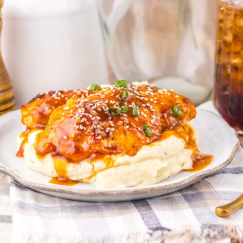 Delicious chicken parmesan topped with marinara sauce and melted cheese, served over creamy mashed p.