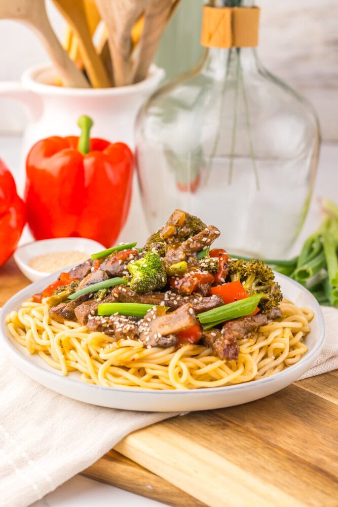 Delicious beef and vegetable stir-fry served over spaghetti, perfect for a quick and flavorful meal.