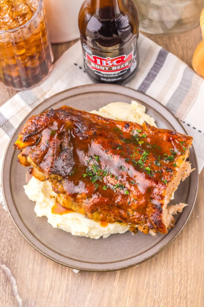 Delicious baked ribs glazed with BBQ sauce served over creamy mashed potatoes. Perfect for a hearty,.