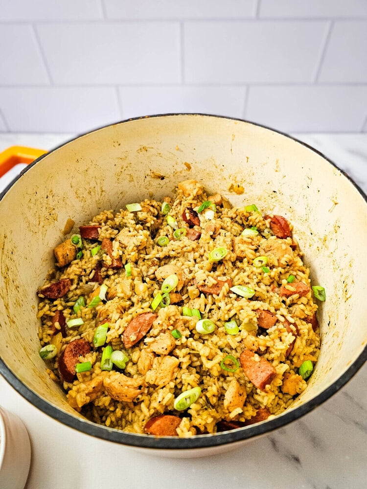 Chicken and rice skillet with sausage and green onions.