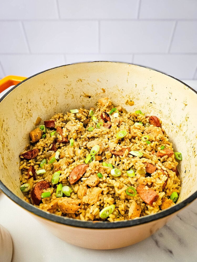 Delicious chicken and rice skillet with vegetables in a cozy cooking pot.