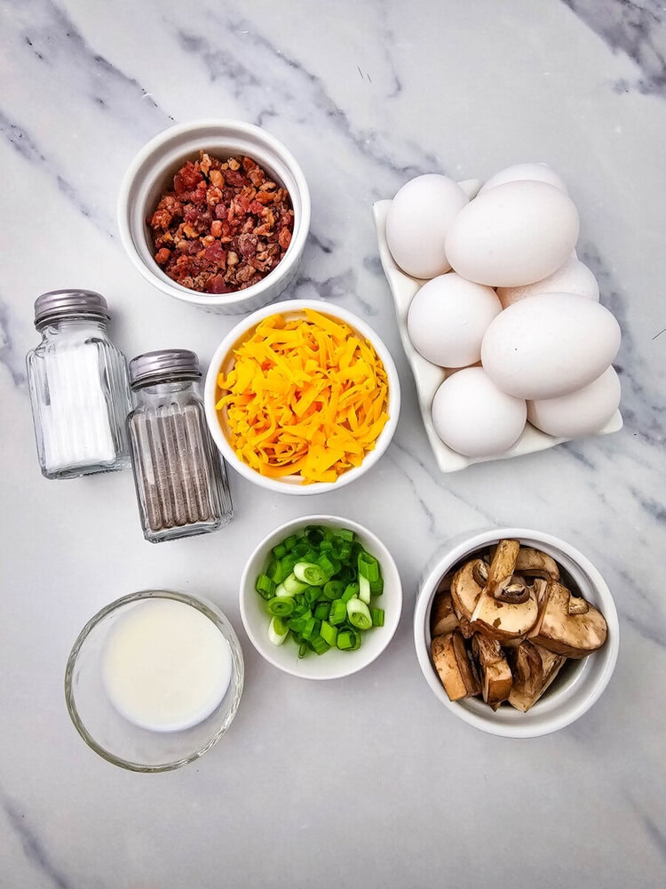 Eggs, bacon bits, shredded cheese, sliced mushrooms, chopped green onions, milk, salt, and pepper on.