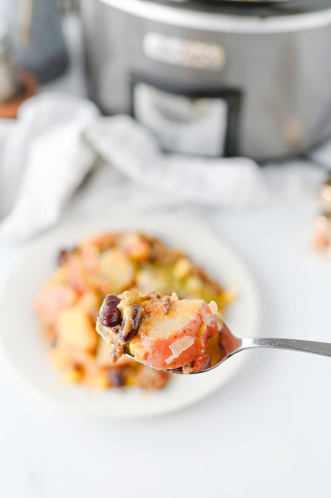 Close-up of a spoonful of hearty chili with beans and vegetables.