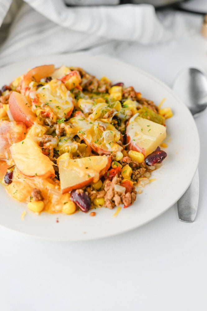 Colorful vegetable and ground beef casserole with melted cheese on top.