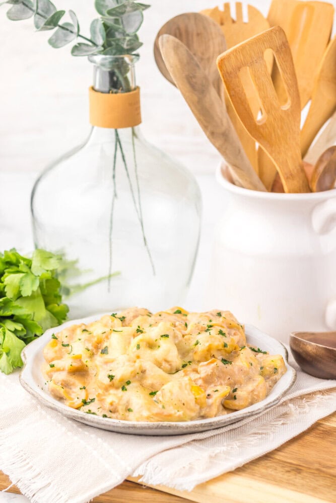 Delicious creamy chicken and mushroom casserole served on a white plate.