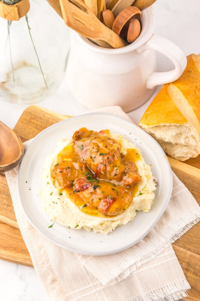 Delicious chicken stew served over creamy mashed potatoes with herbs.