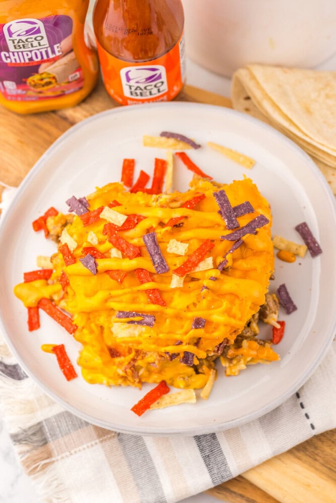 Delicious cheesy taco casserole topped with colorful tortilla strips.